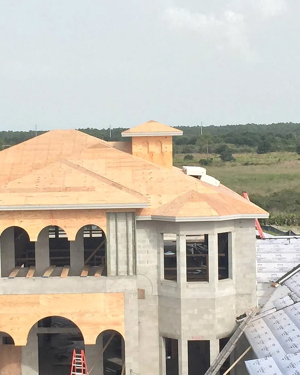 Mediterranean-style custom home with arched openings and a turret framed in Central Florida