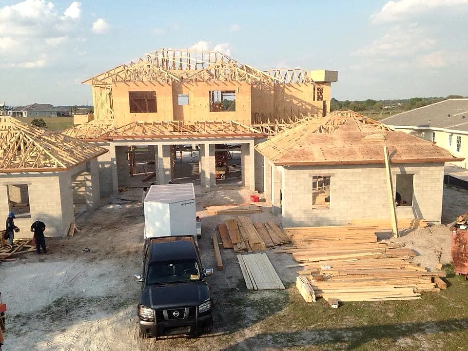 Sprawling framing project with staged lumber, crew and truck on site in Central Florida