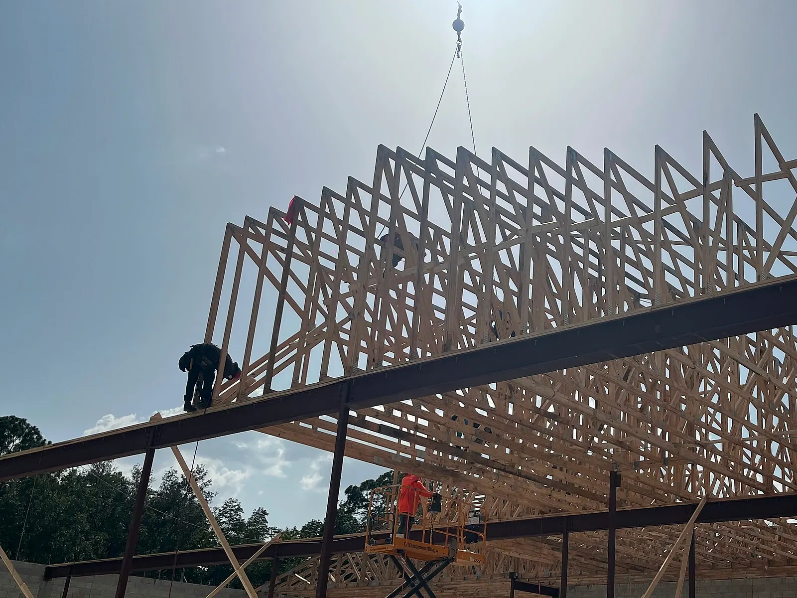 Crane setting a truss package on a Central Florida commercial building