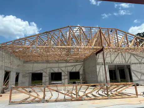 Crown of engineered roof trusses spanning the block walls of a commercial building in Central Florida