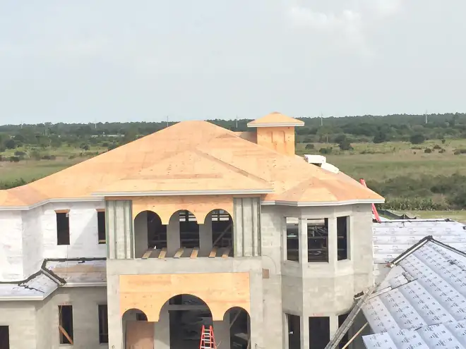 Mediterranean-style custom villa fully framed and sheathed, with arched openings, a turret and bay windows, Central Florida