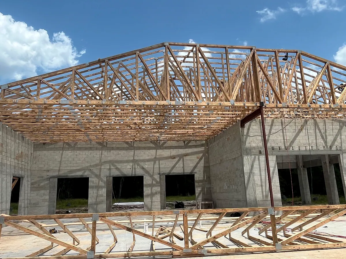 Crown of engineered roof trusses over block walls on a commercial building