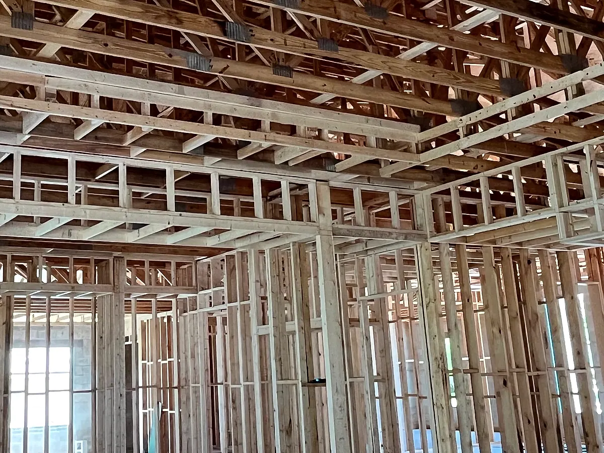 Interior rough framing with wall studs and joists under construction
