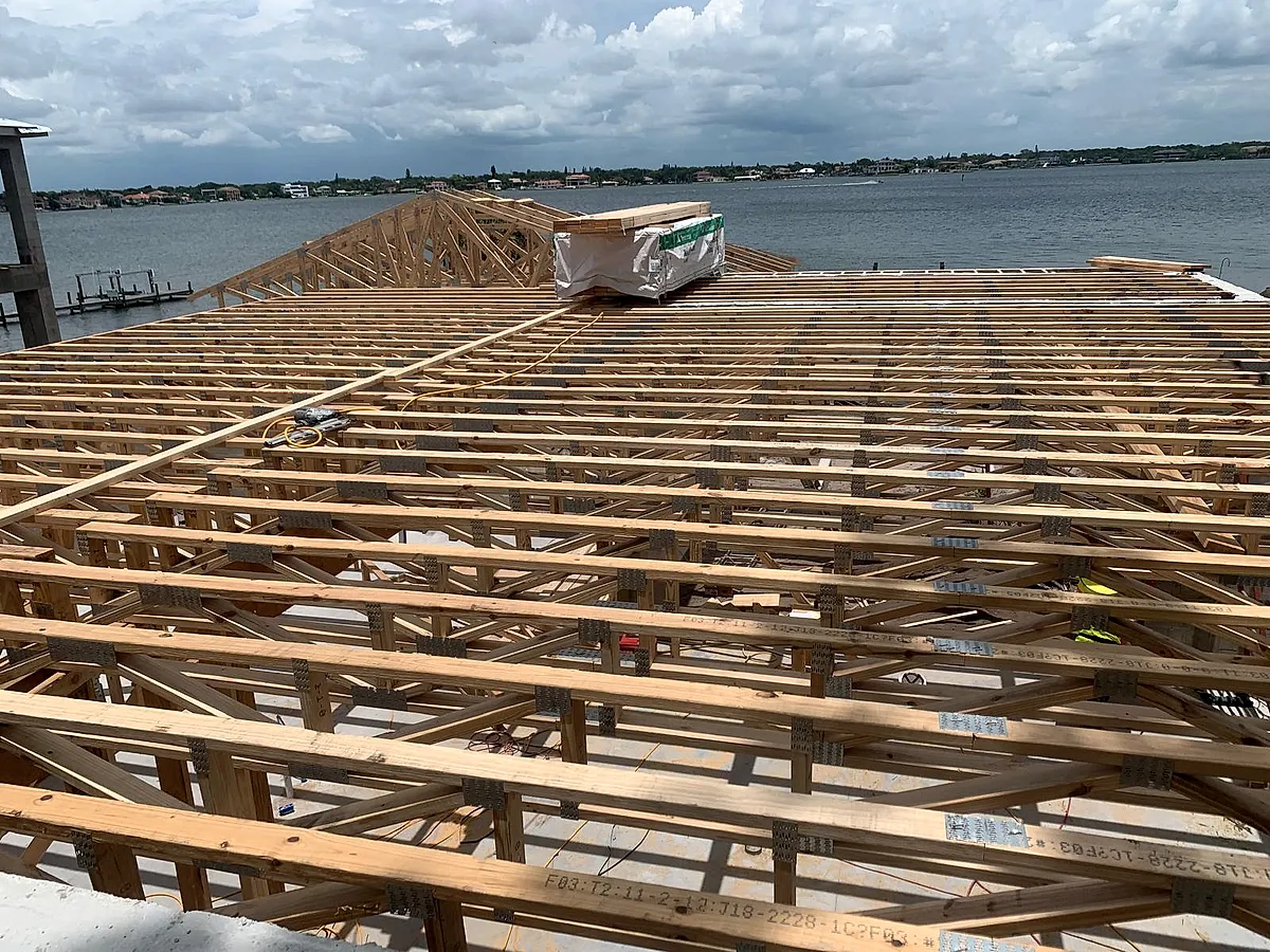 Open-web floor truss system framed over the water on a Central Florida build